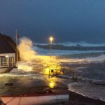 The scene at 8am on Saturday morning as the tide continues to breach the wall